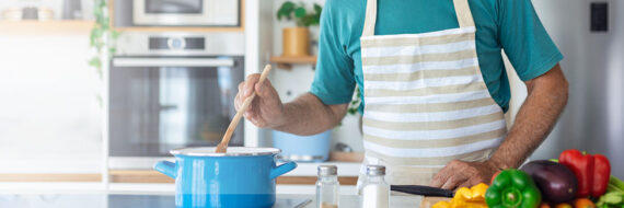 Person stirring pot in kitchen