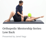 A man performs a low back exam on a woman holding a green ball, showing hands-on training from medbridge.