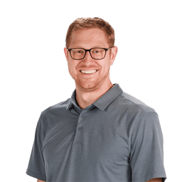 Person smiling in glasses and gray polo shirt, set against a white background, promoting medbridge.