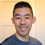 A smiling man in a light blue shirt stands before a cream paneled wall, representing medbridge and healthcare education.