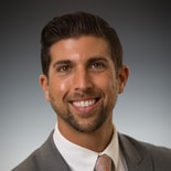 A man in a suit represents Medbridge's digital hybrid healthcare.