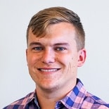 A person with short blonde hair in a plaid shirt represents Medbridge's innovative healthcare approach.