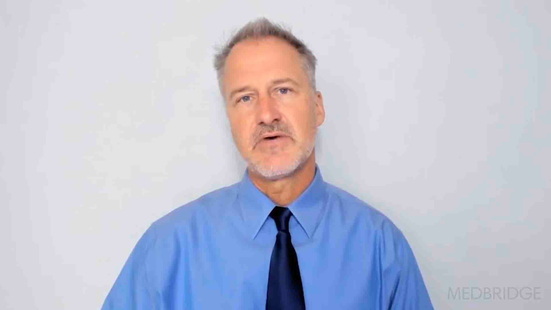 A man in a blue shirt and black tie represents digital healthcare and hybrid care for medbridge.