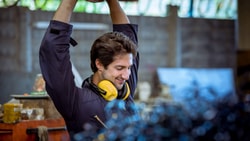 Industrial athlete stretching arms overhead during warm-up to support industrial injury prevention and reduce musculoskeletal strain.