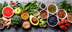 Fresh fruits, veggies, grains, nuts, and seeds on a grey surface, supporting digital healthcare with medbridge software.
