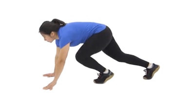 A person in athletic wear does a mountain climber exercise, as seen in medbridge training.