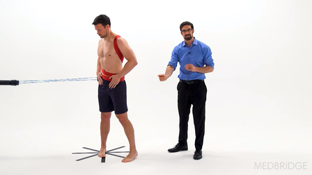 A healthcare training session features a man on a platform and another demonstrating digital methods, highlighting medbridge.