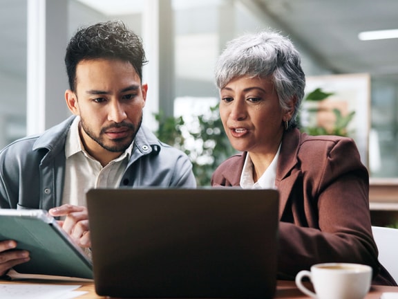 physical therapists in office reading new APTA report