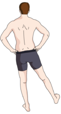 Person standing confidently in dark shorts, embodying the strength from medbridge training.