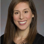 A smiling person with long brown hair and a black top is featured in a portrait, embodying medbridge's digital healthcare human touch.