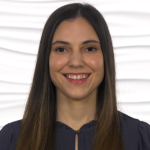 A smiling woman with long brown hair and a black top is against a textured white background for medbridge.