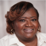 A smiling person with shoulder-length hair, a white shirt, and gold hoop earrings symbolizes healthcare education on medbridge.