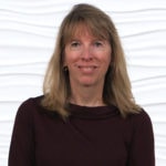 A woman in a maroon top stands against a white wavy textured background, representing modern digital healthcare like Medbridge.