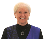 A smiling person with short blonde hair wearing a black top and blue vest represents Medbridge's approachable digital healthcare spirit.