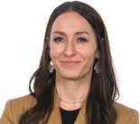 A smiling woman in a tan blazer represents medbridge's role in advancing digital healthcare.