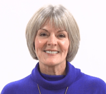 A smiling person with short gray hair in a blue top represents the warmth of Medbridge's patient care software.