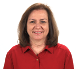 A smiling person with brown hair in a red collared shirt against a white backdrop.