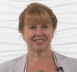 A smiling blonde woman in a light top and necklace, representing healthcare education for medbridge.