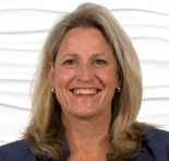 Woman with shoulder-length blonde hair and a blazer, representing innovation in hybrid care for medbridge.