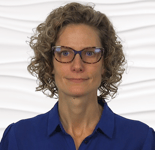 A person with curly hair and glasses in a blue shirt symbolizes medbridge's innovation in digital healthcare education.