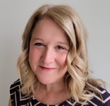 A smiling person with shoulder-length blonde hair, wearing a patterned top, represents the essence of hybrid care by medbridge.
