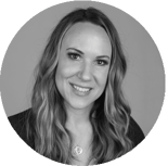 A woman with long wavy hair smiles in a grayscale circular portrait, reflecting professionalism for medbridge.