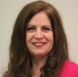 A smiling woman with long brown hair in a pink top represents medbridge's vision for digital healthcare.