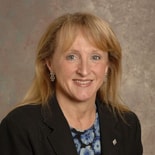 A woman smiles at the camera, representing innovation at medbridge.