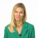 A woman with long blonde hair in a green blazer stands against a white background, representing digital healthcare at medbridge.
