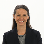 A smiling individual represents the future of digital healthcare in a black blazer and beaded necklace on a white background for medbridge.