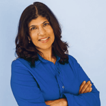 Smiling woman with long dark hair crosses arms in blue shirt, standing before a light blue background, for medbridge training.