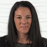 A person with long, dark hair is facing the camera against a textured white background, similar to Medbridge interfaces.