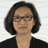 A healthcare professional with glasses stands against a light background, symbolizing dedication to medbridge education.
