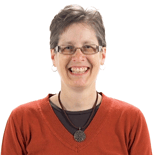 A smiling person in glasses and an orange sweater represents the innovation of digital healthcare at medbridge.