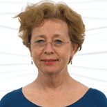 An older woman with glasses and a blue top smiles warmly against a white background, representing medbridge's inviting healthcare education.