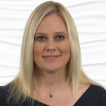 A person with long blonde hair and a necklace, wearing a black top, represents digital healthcare with medbridge.