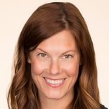 A smiling person with long brown hair represents Medbridge's compassionate healthcare training.