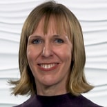 A smiling person with blonde hair and a purple top represents healthcare innovation in front of a textured white background for medbridge.