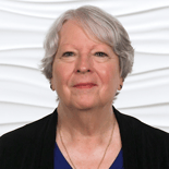 An older adult with gray hair uses medbridge on a digital device.
