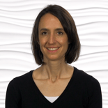 A smiling woman with shoulder-length hair represents the future of hybrid care in front of a textured background, part of medbridge.