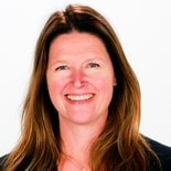 Person with long brown hair in a dark top smiles, illustrating Medbridge's digital healthcare advantages.