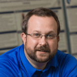 A confident, bearded person in a blue polo represents digital healthcare innovation at medbridge.