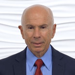 A bald older man in a suit and tie exudes authority against a textured white backdrop, representing professionalism in digital healthcare for medbridge.