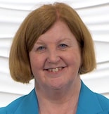 A smiling person with short red hair and a blue shirt represents medbridge's impact on patient care.