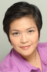 Smiling person with short, dark hair in a purple shirt and pearl necklace, passionate about digital healthcare and innovative solutions for Medbridge.