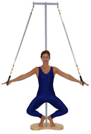 A person in a blue bodysuit performs a suspended exercise on a vertical pole, symbolizing medbridge's focus on balance and control.