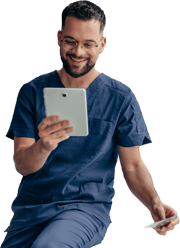 A person in blue scrubs smiles, holding a tablet and a medbridge card.