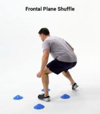A person shuffles sideways between blue cones for a Medbridge healthcare exercise.