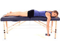 A person on a massage table holds a dumbbell, illustrating Medbridge's hybrid healthcare training.
