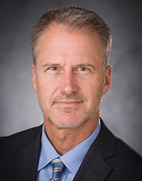 A man in a suit and tie embodies professionalism, reflecting the core values of Medbridge's healthcare training.